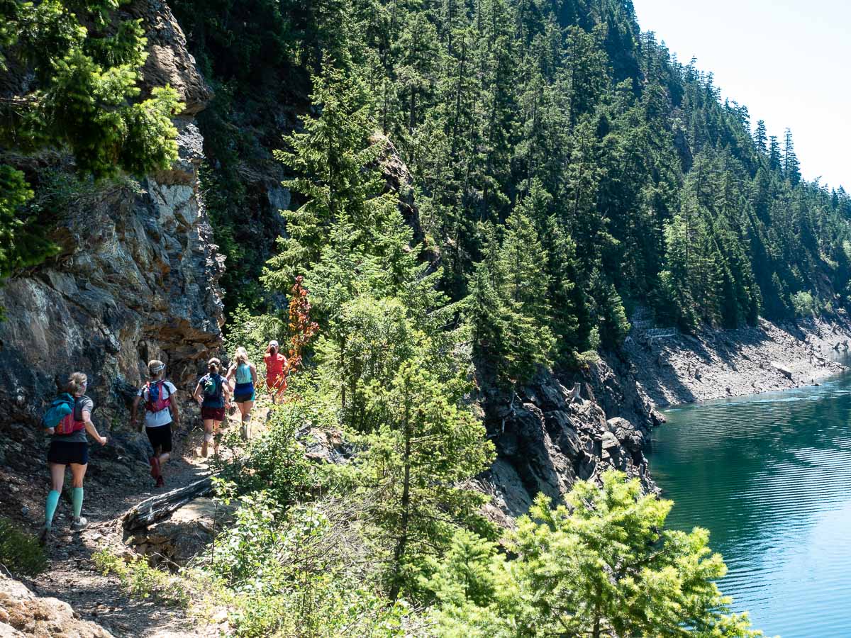 trail runners alongside Ross Lake in the North Cascades
