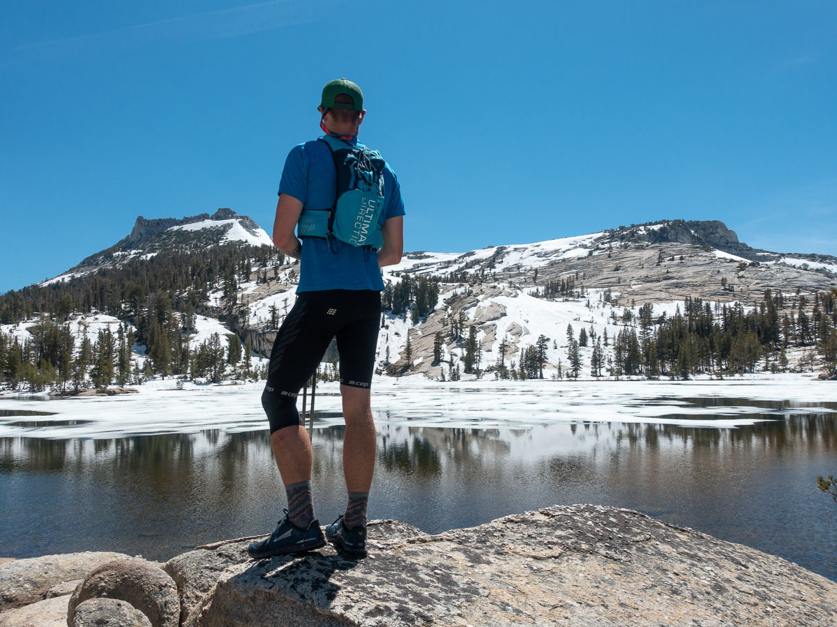 A man gazes over an alpine lake in the High Sierra