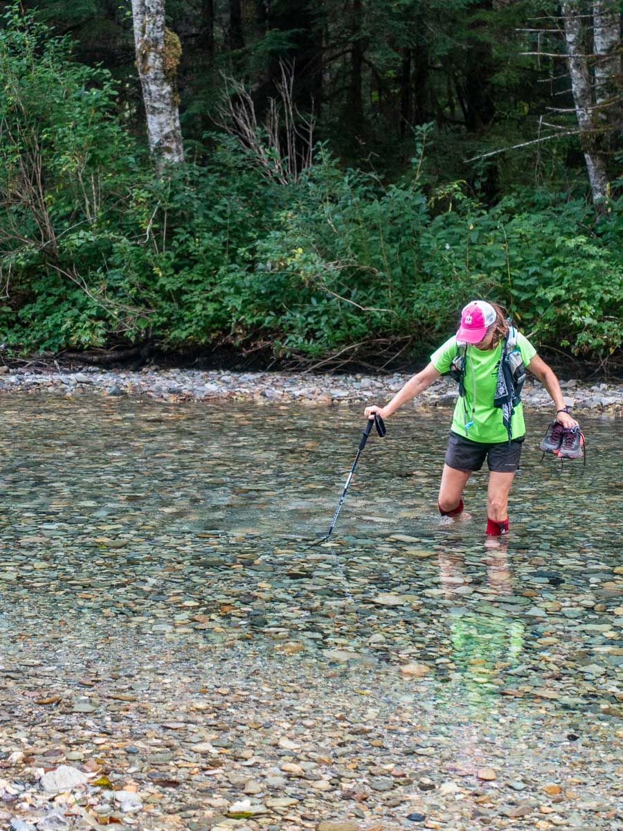 a trail runner fords a river